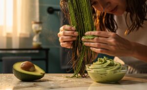 Illustration of an avocado hair mask being applied to dry, damaged hair to restore shine in 30 minutes