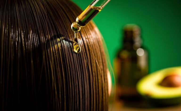Illustration of avocado oil being applied to hair to boost shine in a single application.